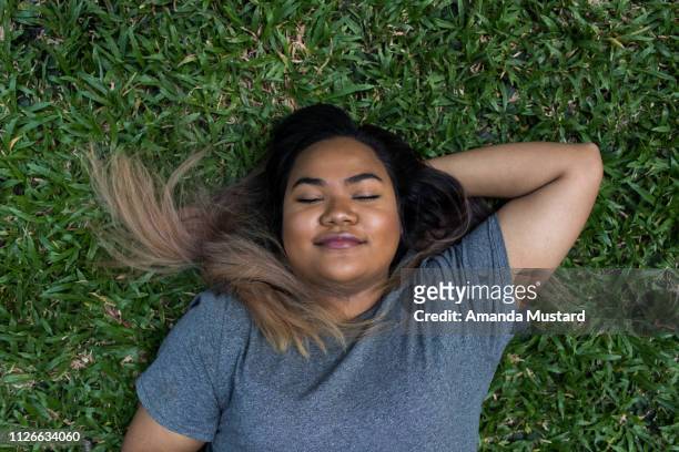 Young Mixed Race Woman Lying in the Grass
