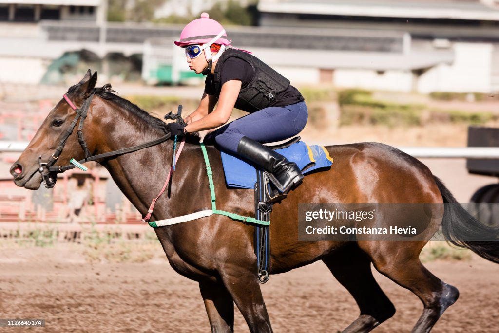 Woman Jockey riding a horse