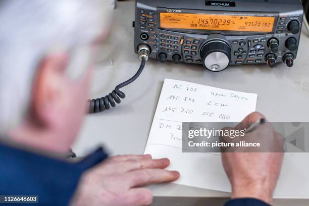 February 2019, North Rhine-Westphalia, Bochum: Guido Elsner, employee at the observatory, notes down radio frequencies and identifiers on a piece of...