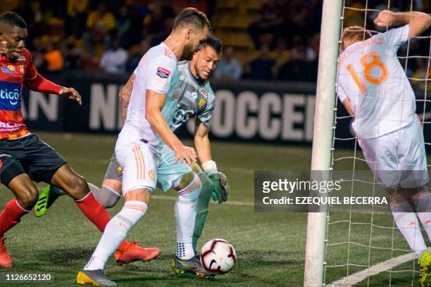 Costa Rica's Club Sport Herediano Keyner Brown and goal keeper Daniel Cambronero vie for the ball with United States United Atlanta FC Leandro...