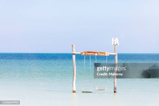 beach swing in the water - isla holbox fotografías e imágenes de stock