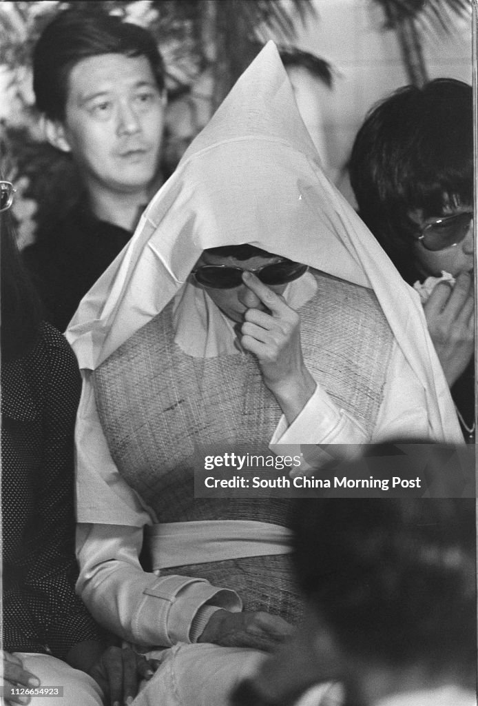 Black and white photo.  Widow of Bruce Lee Siu-lung, Linda Lee Cadwell, is accompanied by the friends and relatives at the funeral of the famous kungfu actor.  25 July 1973