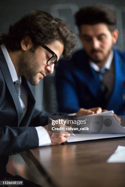 signing official document - securities litigation stock pictures, royalty-free photos & images
