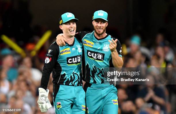 Jimmy Peirson of the Heat celebrates with team mate Chris Lynn after taking the wicket of Nick Hobson of the Scorchers during the Big Bash League...