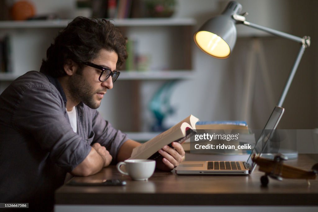 Man reading book on the table