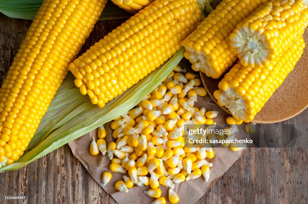 Ripe golden corn on wooden background