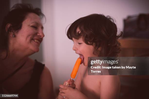grandma giving ice cream to toddler - candy on tongue stock pictures, royalty-free photos & images