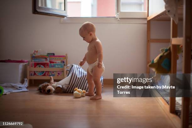 baby boy looking at toys - playroom stock pictures, royalty-free photos & images