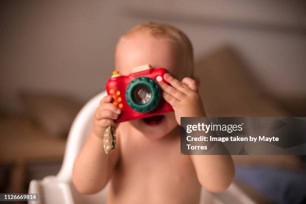 baby boy taking a photo with a toy camera - toy camera stock pictures, royalty-free photos & images