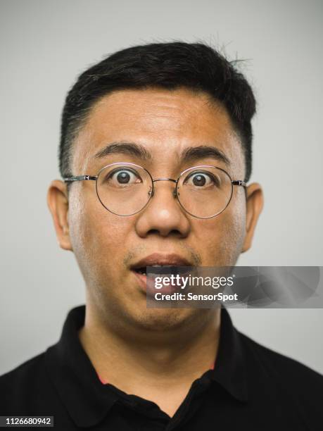 real chinese man with surprised expression - awe expression stock pictures, royalty-free photos & images