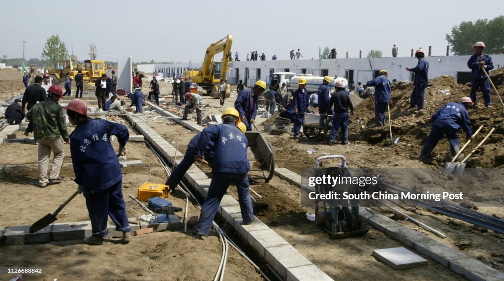 Workers start work on one of the new prefabricated hospital wards that are being built to house SARS patients at the Xiaotangshan hospital complex in the north of Beijing. The work at the complex is being rushed for the arrival of patients from Beijing. 2