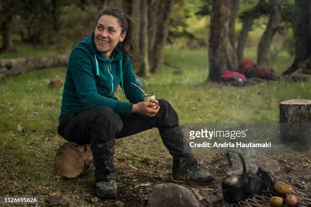 Chilean woman drinks yerba mate tea while camping