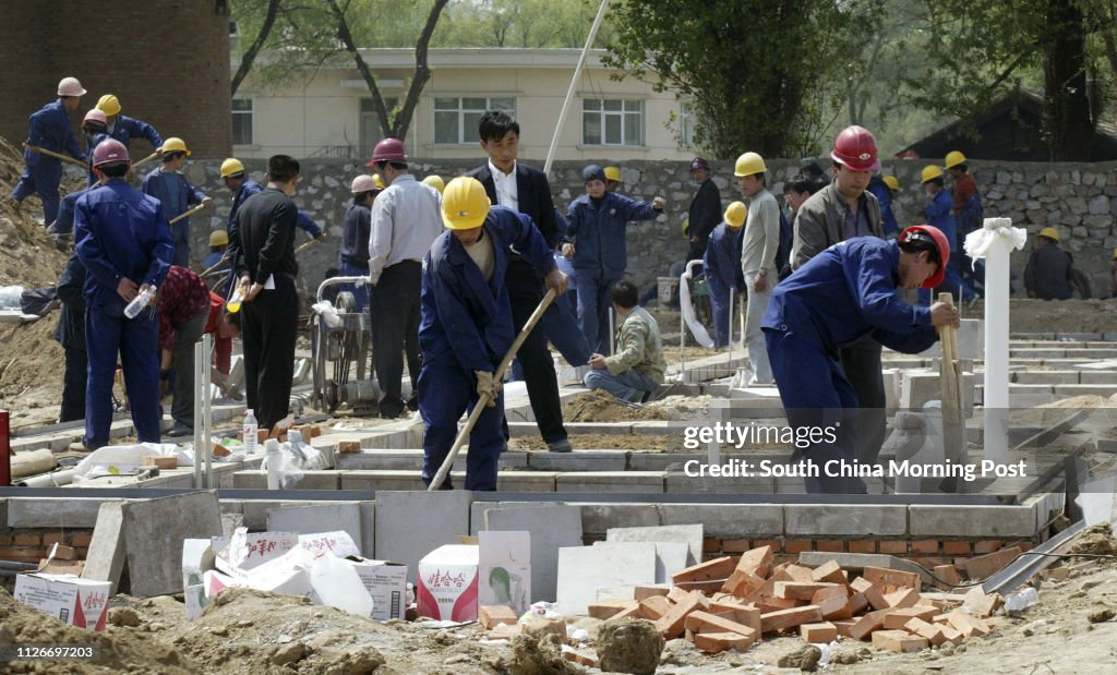 Workers start work on one of the new prefabricated hospital wards that are being built to house SARS patients at the Xiaotangshan hospital complex in the north of Beijing. The work at the complex is being rushed for the arrival of patients from Beijing. 2