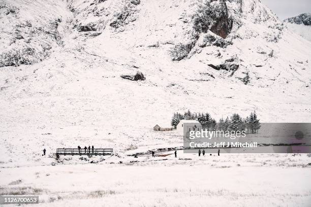 Members of the public take pictures of Lagangarbh cottage below Buachaille Etive Mor on February 1, 2019 in Glen Coe Scotland. The Met office have...