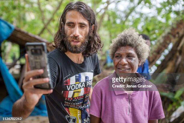 Kurdish asylum seeker Behrouz Boochani takes a selfie with one of the locals on a neighboring island to Manus island. The human cost of Australias...