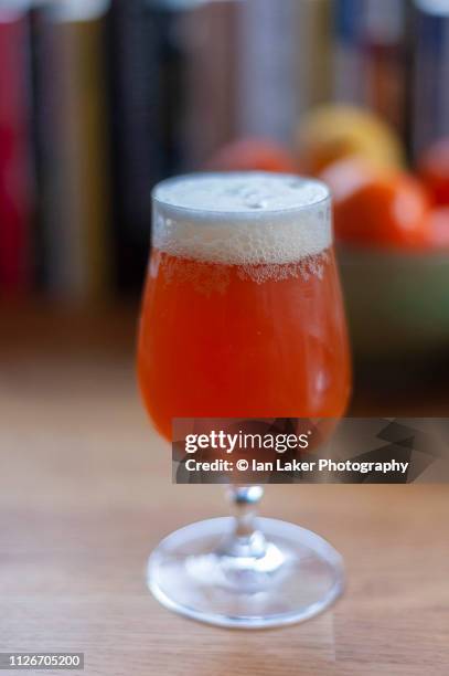 littlebourne, canterbury, england. 20 january 2019. stemmed glass of craft beer, on table, shot from the side in natural soft light with shallow depth of field - ale stock pictures, royalty-free photos & images