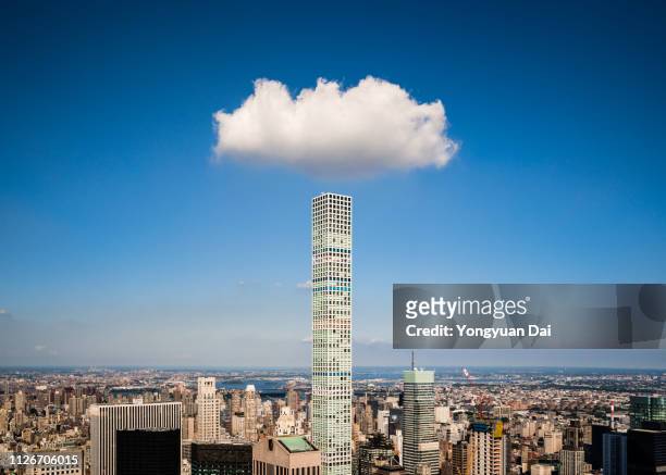 cloud over a modern skyscraper - grattacielo foto e immagini stock