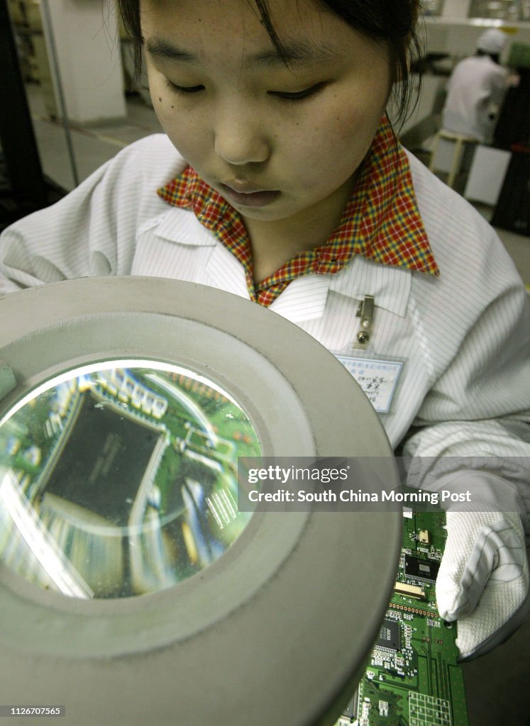 A worker at work in the Ya Hsin Industrial Company Ltd, a manufacturer of Rigid & Flexible PC Board in Shi Jie Town, Dongguan City, China. 27 February 2003