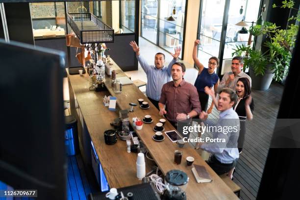 business people watching sport on television - watching sport television stock pictures, royalty-free photos & images
