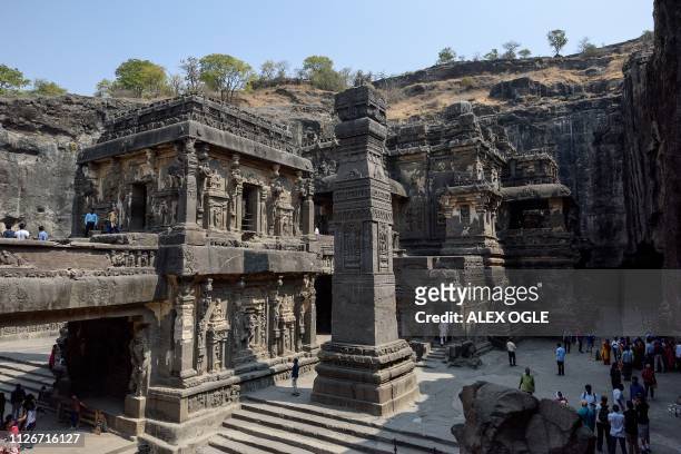 This photo taken on February 21 shows visitors in the Kailasa rock-cut Hindu temple complex at the Ellora Caves in India's Maharashtra state. The...