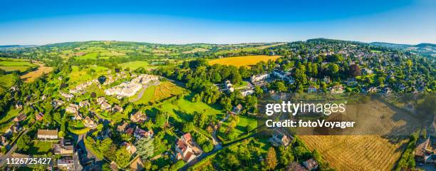 idyllic summer countryside picturesque village green farms fields aerial panorama - cotswolds stock pictures, royalty-free photos & images