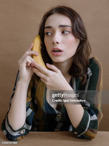 young woman posing in studio - banana phone stock pictures, royalty-free photos & images