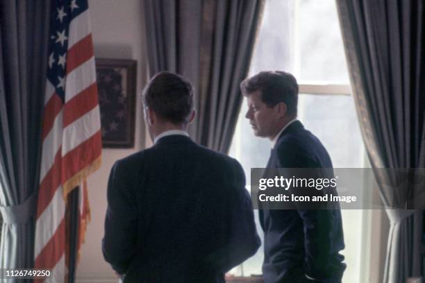 Former United States Senator and Attorney General, Robert F. Kennedy, and his brother, President John F. Kennedy, confer in the Oval Office of The...