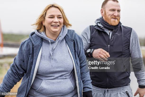 bad weather fitness training with coach - fat redhead stock pictures, royalty-free photos & images
