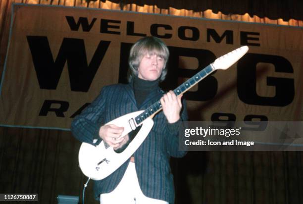 Brian Jones , founding member and guitarist for The Rolling Stones, plays his iconic white Vox teardrop guitar during their second tour of the US,...
