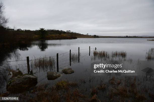 Fence disappears into a lake to mark the boundary between Northern Ireland and the Republic of Ireland on February 11, 2019 in Tully, Ireland. The...
