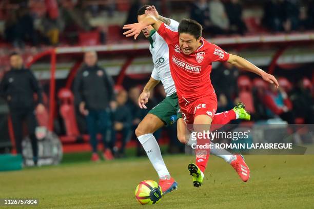 Dijon's South Korean midfielder Kwon Chang-hoon vies with Saint-Etienne's French midfielder Thimothee Kolodziejczak during the French L1 football...