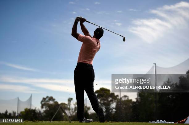 Golfer Tiger Woods practises a shot during the second round of the World Golf Championship in Mexico City, on February 22, 2019. - The WGC-Mexico...