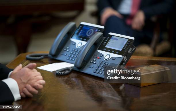 Telephone sits on the Resolute Desk as U.S. President Donald Trump speaks during a trade meeting with Liu He, China's vice premier and director of...