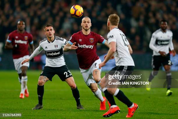 West Ham United's Austrian midfielder Marko Arnautovic vies with Fulham's English defender Joe Bryan during the English Premier League football match...