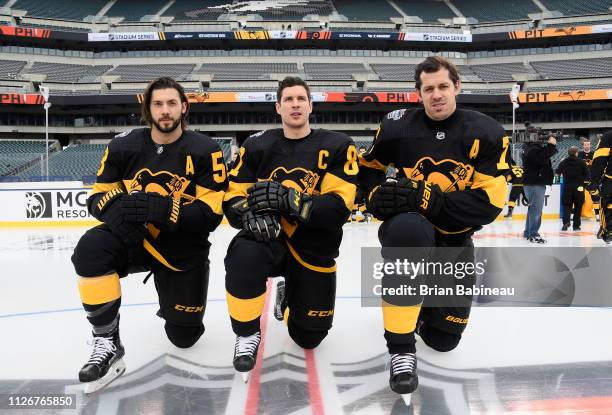 Kris Letang, Sidney Crosby and Evgeni Malkin of the Pittsburgh Penguins kneel for the team picture before practice at Lincoln Financial Field ahead...