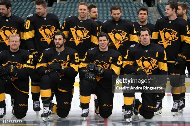 Kris Letang, Sidney Crosby and Evgeni Malkin of the Pittsburgh Penguins kneel for the team picture before practice at Lincoln Financial Field ahead...