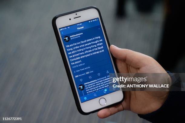 The @HKsisters6 Twitter account feed of Saudi sisters Rawan and Reem is held by Reem during an interview with AFP in Hong Kong on February 22, 2019....