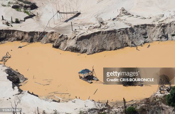 Aerial view taken on February 22, 2019 of a dismantled gold digging system located near the illegal gold miners' camp "Mega 12", in the Amazon jungle...
