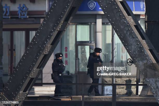 Chinese policemen patrol at the customs checkpoint on the Sino-Korean Friendship Bridge, which spans the Yalu River between China and North Korea, in...