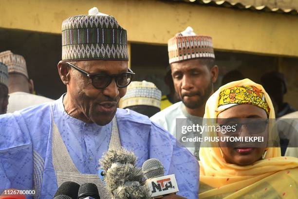 Candidate of the All Progressives Congress and incumbent President Muhammadu Buhari , flanked by his wife Aisha Buhari , speaks after voting at a...