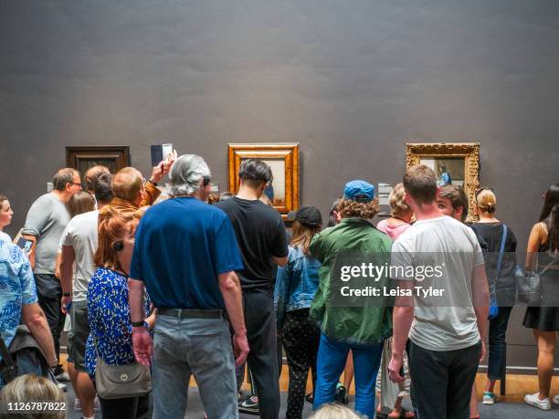 Tourists in front of The Milkmaid, a painting by Johannes Vermeer at the Rijksmuseum in Amsterdam, The Netherlands. Johannes Vermeer was a Dutch...
