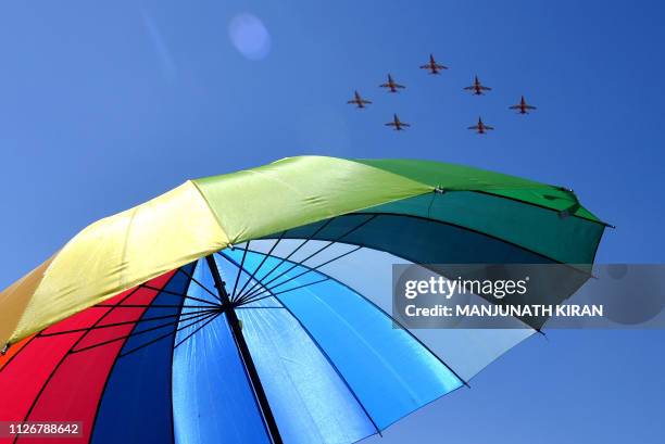 Surya Kiran Aerobatics team flying Advance Jet Trainer Hawk MK-132 fly in formation on the fourth day of the five-day Aero India 2019 Airshow at the...