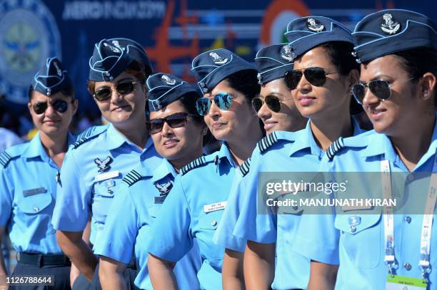 Female officers of the Indian Air Force pose for a photograph as part of 'Aero India Womens Day -- to celebrate the contribution of women in aviation...
