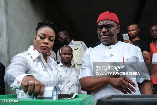 Rivers state's Governor Ezenwo Nyesom Wike and his wife and Eberechi Wike cast their ballot as voting in the presidential and parliamentary elections...