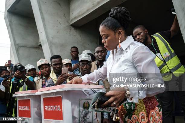 Eberechi Wike, wife of Rivers state's Governor Ezenwo Nyesom Wike, casts her ballot as voting in the presidential and parliamentary elections on...