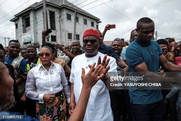 Rivers state's Governor Ezenwo Nyesom Wike and his wife Eberechi Wike leave after voting in the presidential and parliamentary elections on February...
