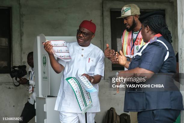 Rivers state's Governor Ezenwo Nyesom Wike walks to cast his vote in the presidential and parliamentary elections on February 23 at a polling station...