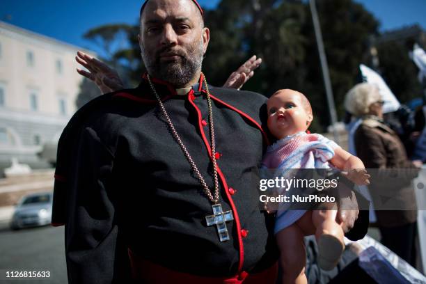 Man dressed like a cardinal takes part in the March for Zero Tolerance, during the four-day meeting on the global sexual abuse crisis at the Vatican,...