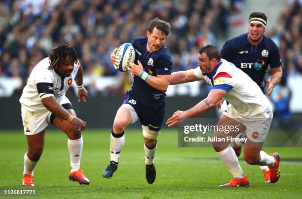 Pete Horne of Scotland runs past Louis Picamoles and Mathieu Bastareaud of France during the Guinness Six Nations match between France and Scotland...