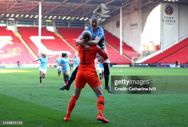 Janine Beckie of Manchester City Women celebrates with teammate Karen Bardsley after scoring the winning penalty during the FA Women's Continental...